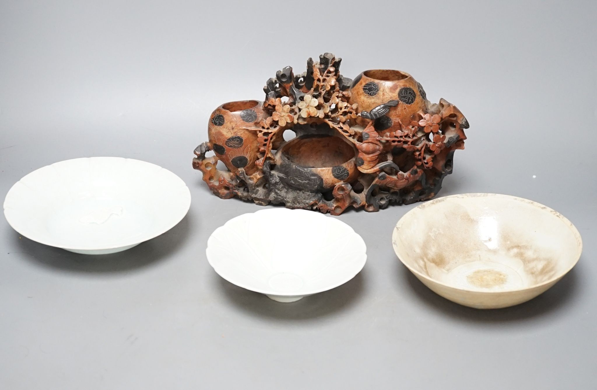 A Chinese soapstone carving, three Qingbai type bowls, 29cm